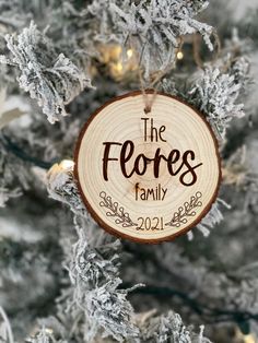 a wooden ornament with the words the flores family hanging on a christmas tree