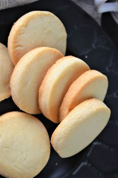 a black plate topped with cookies on top of a table