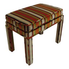 an upholstered stool with multicolored stripes