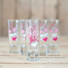 the shot glasses are decorated with pink bows and polka dot designs on clear glassware