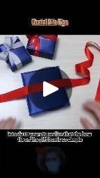 someone is wrapping presents with red and blue ribbons