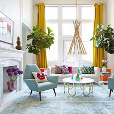 a living room filled with furniture and a fire place in front of a large window