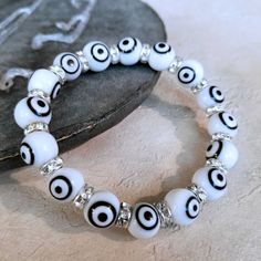 Handmade Evil Eye Bracelet Features 10mm Diameter Turkish Evil Eye Glass Beads With Black And White "Eye" Features 7mm Egyptian Crystal Rondelles With Silver Plating Each Bracelet (And Each Glass Bead!) Is Unique And Just A Bit Different Due To Its Handcrafted Nature Average Inside Measurement Is 6.5" Unstretched The Evil "Eye" On These Beads Is Believed In Many Parts Of The World To Be A Talisman That Helps Ward Off Evil And Bad Fortune Evil Eye Jewelry Is Worn For Protection Of The Wearer Handmade Evil Eye, Turkish Evil Eye, Eye Glass, Eye Bracelet, Gold Bangle Bracelet, Evil Eye Bracelet, Evil Eye Jewelry, Eye Jewelry, Pink Bracelet