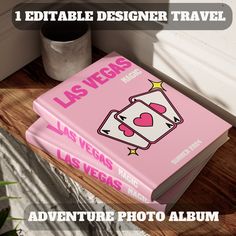 a pink book sitting on top of a wooden table next to a potted plant