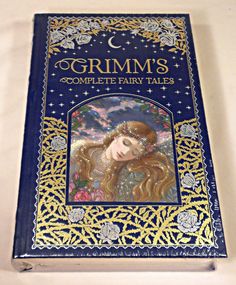 the book grim's complete fairy tales is shown in blue and gold trimming