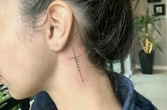 a woman with a small tattoo on her neck