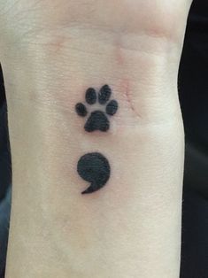 a small paw print on the wrist with a speech bubble in it's center