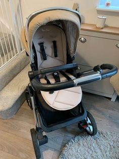 a baby stroller sitting on top of a wooden floor