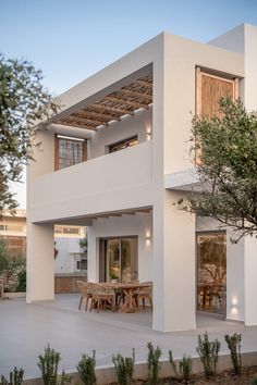 a white house with an outdoor dining area