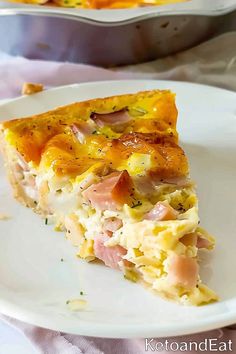 a slice of ham and cheese quiche on a plate