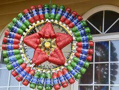 a ferris wheel made out of soda cans with a star on the front and side