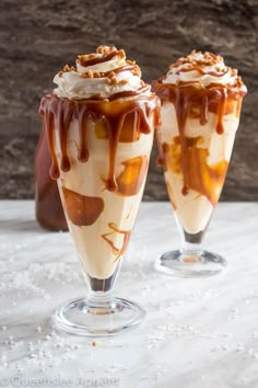 two glasses filled with ice cream and caramel drizzle