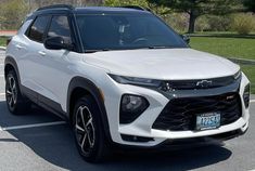 a white suv parked in a parking lot