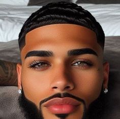 a man with a beard and piercings on his face is laying down in bed