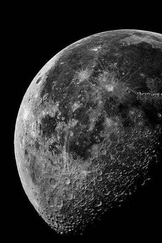 an image of the moon taken from space in black and white with some color to it