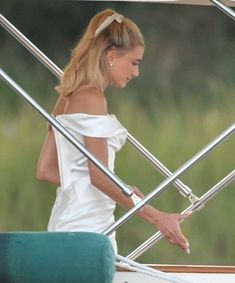 a woman in a white dress on a boat