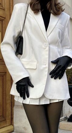 a mannequin dressed in black tights and a white suit with long sleeves