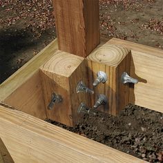 a wooden box with screws and nails in it