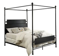 a black metal bed frame with white sheets and pillows on the bottom, in front of a white background