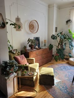 a living room filled with furniture and lots of plants