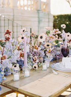 the table is set with candles and flowers