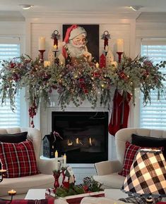 a living room filled with furniture and a fire place covered in christmas decorations on top of a mantel