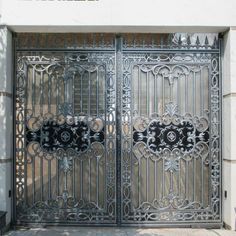 an ornate iron gate on the side of a building