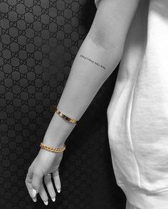 a woman's arm with a gold bracelet on her left wrist and an inscription that reads, there is no place like home