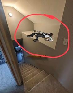 an image of a cartoon character on the wall above some stairs with a red circle over it