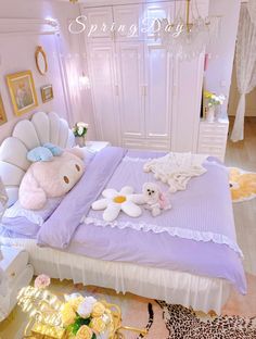 there is a teddy bear on the bed with other stuff animals and flowers in front of it