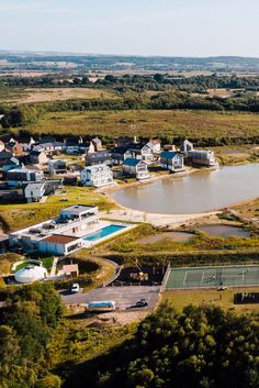 an aerial view of a tennis court surrounded by houses