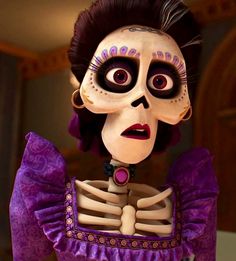 a skeleton dressed up as a woman in a purple dress with black hair and makeup