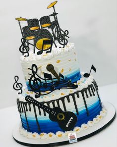 a three tiered cake decorated with musical instruments