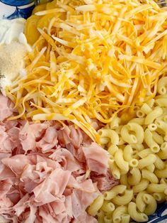 pasta, ham and cheese are mixed together in a bowl