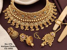 Description :- Gold Choker Necklace Sets / South Indian Jewelry/Punjabi Choker/ Temple Necklace /Antique Wedding choker Necklace/Indian Wedding Jewelry All the raw material used in this product is of high quality and is handcrafted with love. Premium Quality and High craftsmanship 100% Satisfaction Guarantee: Long Lasting Plating, High-Quality Stones. Gifting: This pair of charming necklace and earrings come in a beautiful gift box, making it an ideal gift for birthday, wedding anniversary or we Luxury Heavy Temple Necklace In Fusion Style, Luxury Gold Sets For Reception, Luxury Gold Plated Kundan Necklace For Reception, Luxury Gold Temple Necklace With Elegant Design, 22k Gold Necklace Indian Jewelry Kameswari Jewellers, Luxury Gold Jewelry For Traditional Ceremonies, Luxury Gold Plated Chandbali Necklaces, Luxury Gold Sets With Motifs, Luxury Intricate Design Temple Necklace In Yellow Gold