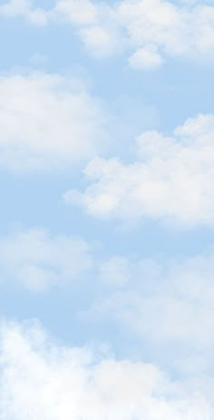 an airplane flying high in the sky with white clouds behind it and blue skies above