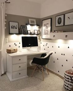 a white desk topped with a computer on top of a wooden desk next to a window