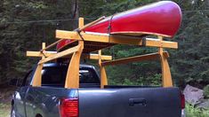 a gray truck with a red canoe on the back