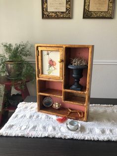 an old wooden cabinet with pictures on it