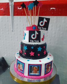 a three tiered cake decorated with photos and music notes on it's sides