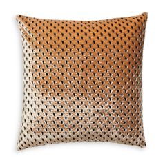 an orange and black pillow on a white background, with small holes in the fabric