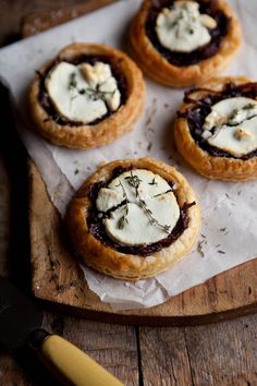 three small pastries with cream cheese and herbs on top