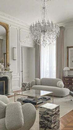 a living room filled with furniture and a chandelier