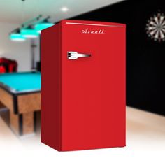 a red refrigerator sitting next to a pool table