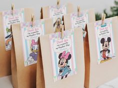 there are many bags with tags on them that say thank you and mickey mouses