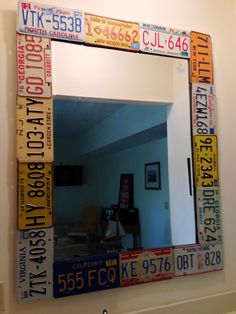 a mirror made out of license plates on the side of a wall in a room