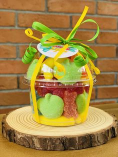 a jar filled with gummy bears sitting on top of a wooden table