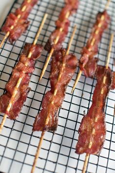 bacon skewers on a wire rack with toothpicks sticking out of them