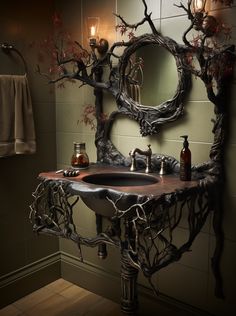 a bathroom sink sitting under a mirror next to a wall mounted faucet with branches on it