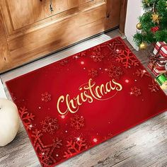 a red christmas door mat with the word christmas on it